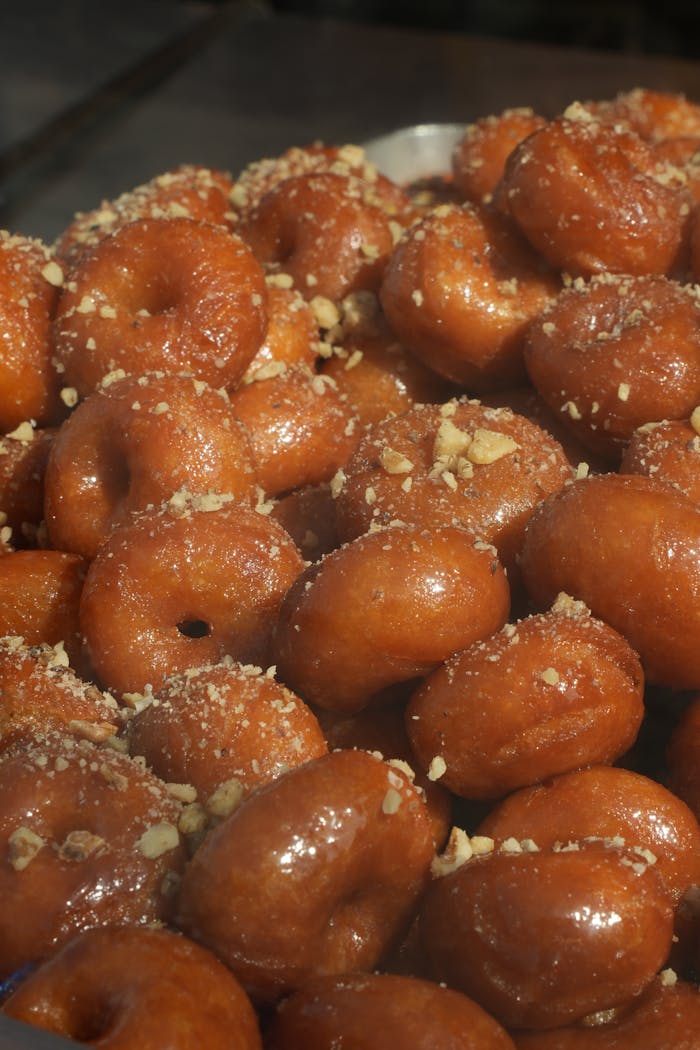 why-choose-us-01 Delicious honey-glazed lokma pastries topped with crushed nuts, perfect for a sweet treat.